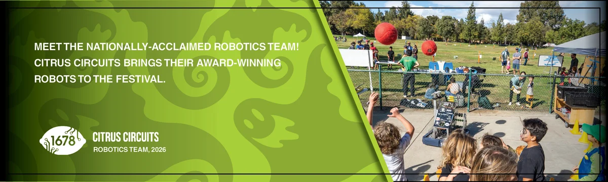 Children watch robots launch balls inside a fenced arena on the park lawn.