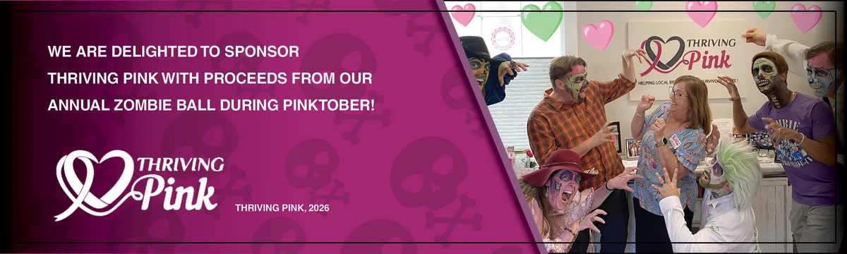 Costumed zombies pose around a Thriving Pink banner indoors.