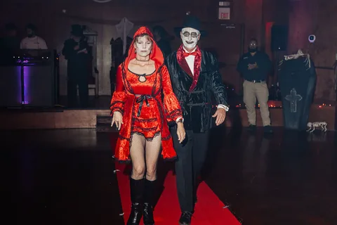 The same costumed couple continues walking down the runway.