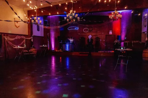Colorful lights glow over the empty dance floor before guests arrive.