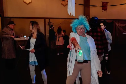 Guests walk through a dark room, blurred by motion.