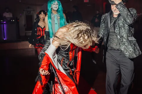 Two guests are caught mid-motion on the red carpet runway.