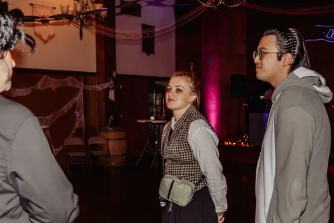 Guests walk through the venue, blurred and dimly lit.