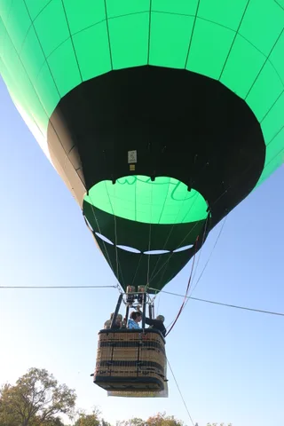 Another dramatic upward view through the balloon envelope toward the basket and sky.