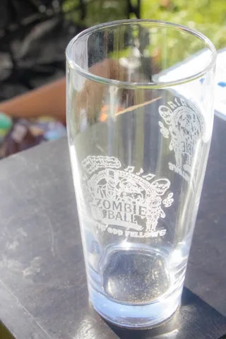 A close, blurred view of an engraved glass commemorating the event.
