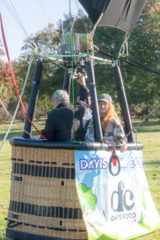 The Davis Food Co-op banner fills most of the frame with a rider barely visible above.