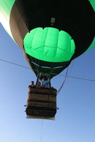 A close view of the green balloon fabric with a hand-drawn logo.