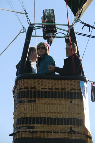 Two men talk quietly in the basket before launch.