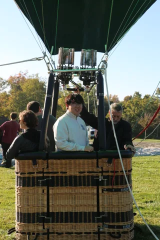 The teenager continues chatting with the group as the balloon holds steady.