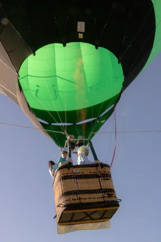 An extreme close-up of green balloon fabric texture, no basket or people visible.