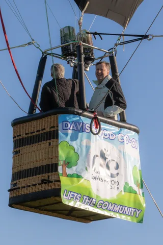The empty basket rises with the Davis Co-op logo faintly visible on its banner.