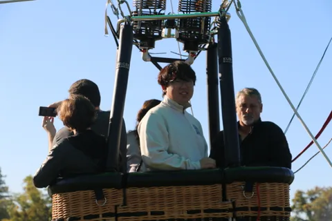A rider photographs the group from the basket.