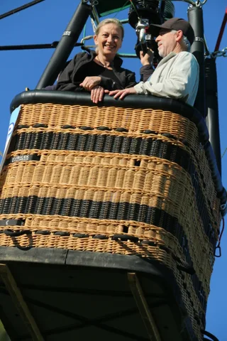 The empty wicker basket fills the frame against clear sky.