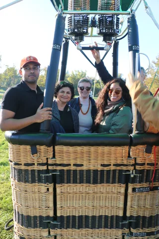 A cheerful group celebrates together in the basket.