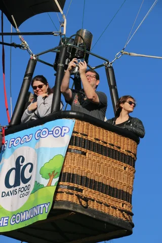 The Davis Food Co-op banner reads Lifts the Community on the basket.