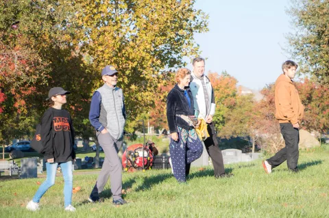 A similar group continues walking across the field a moment later.