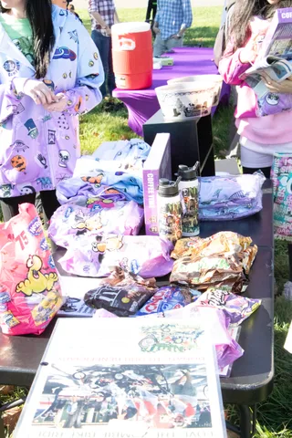 A table of Halloween-themed cups and craft supplies at an event booth.