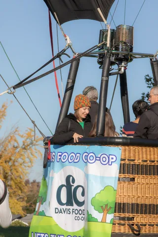 The bottom of the balloon basket shows the Davis Food Co-op logo, no people visible.