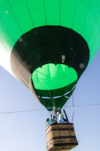 A close view of the bottom of the green balloon envelope with no basket or people.