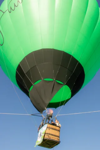 The underside of the green balloon envelope fills the frame in saturated color.