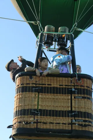 Riders react and laugh together in the basket.
