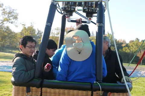 A rider checks his phone while the group waits in the basket.