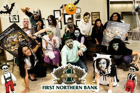 A costumed group poses together inside First Northern Bank.