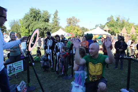 A lively crowd fills the park during the community event
