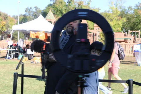 The 360 photo booth ring light beside event booths