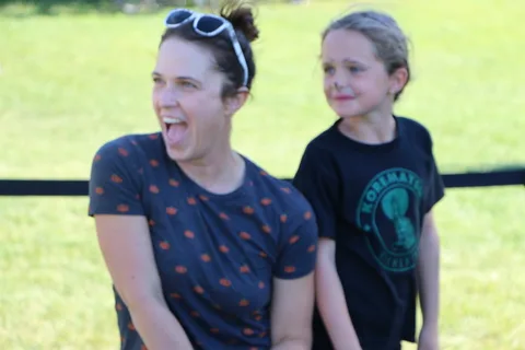 A mother and daughter laugh together at the festival.