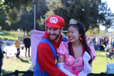 A couple dressed as Mario and Princess Peach pose together at the festival.
