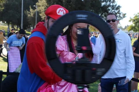 A costumed guest poses inside the 360 photo booth ring