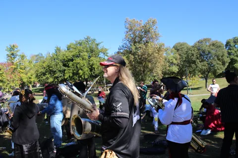 Band members in costume gather with their instruments before the parade.