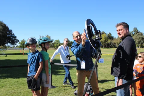 A photographer sets up to photograph two boys at the booth.
