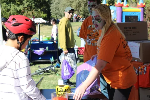 Guests in costume browse a prize table at the festival.