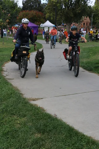 A crowd of costumed riders fills the path at the parade