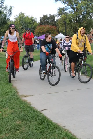 A group of cyclists rides along the park path