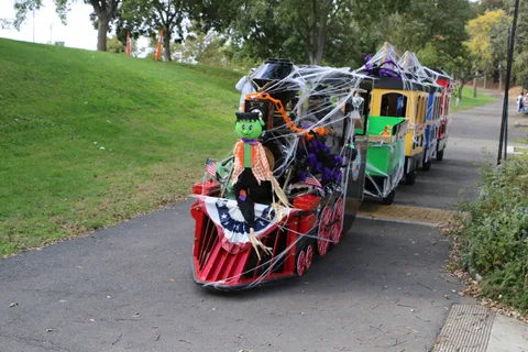 A brightly decorated parade trike rolls through the event