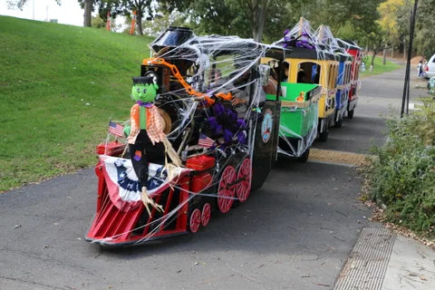 Decorated train ride with costumed riders at the outdoor festival