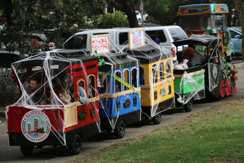 A vibrantly decorated parade vehicle with participants