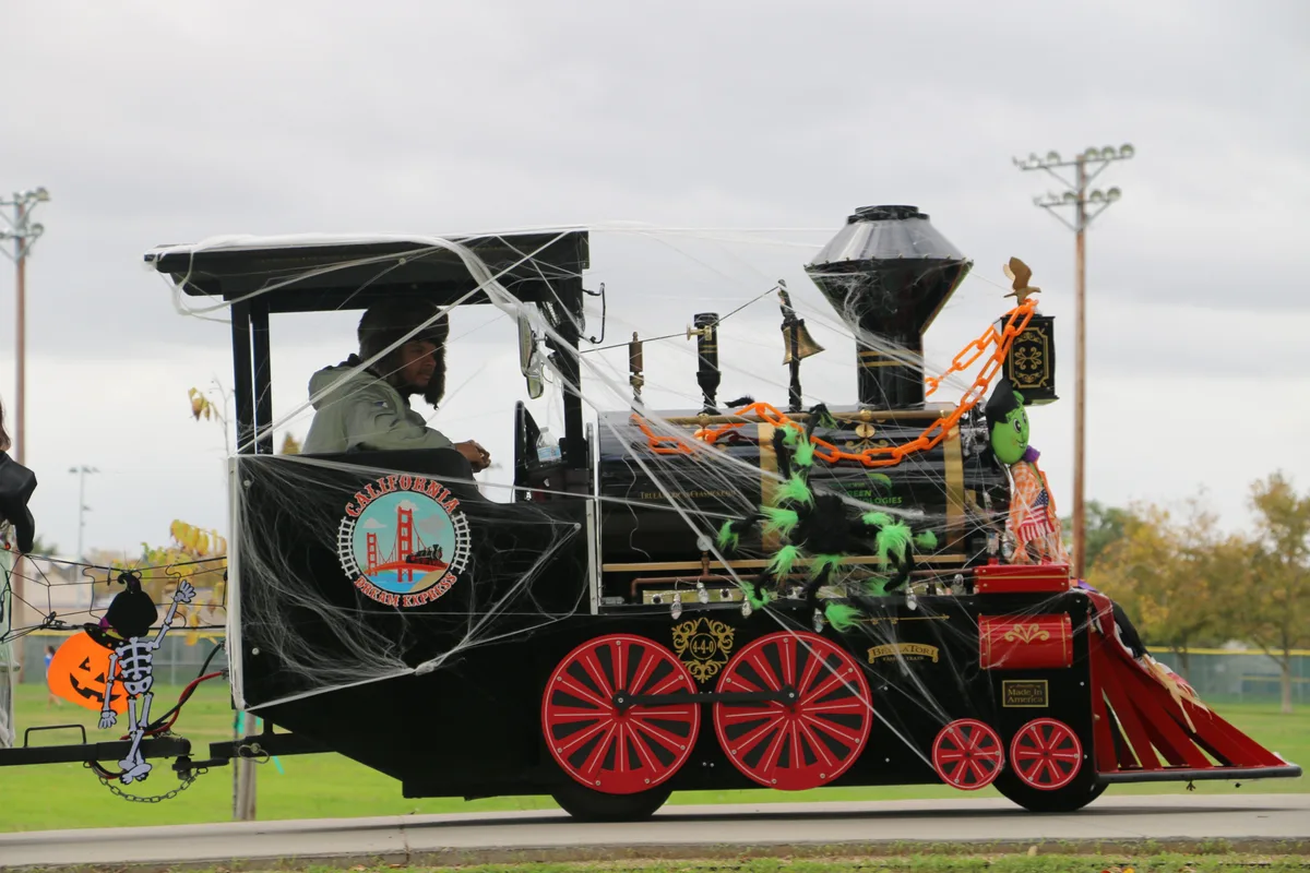 Families ride a miniature festival train through Community Park