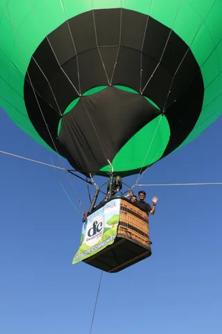 The balloon basket floats away carrying the Davis Food Co-op banner.
