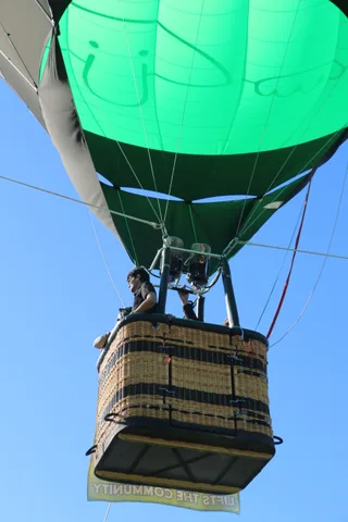 Close view of the green balloon envelope fabric with faint painted lettering.