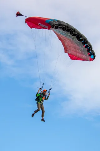A red canopy banks into a turn on the way down.