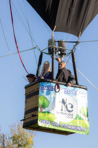 Passengers ride together in a sponsored balloon basket