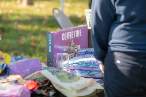 Festival merchandise laid out on a table on the grass