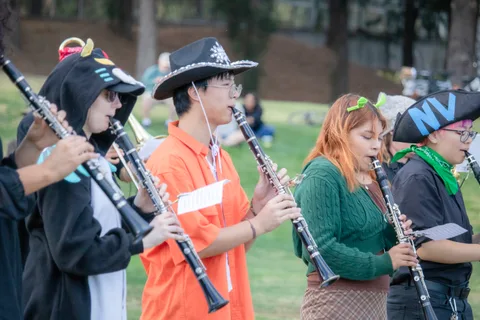 Clarinet players in pirate hats and costume perform in a row.