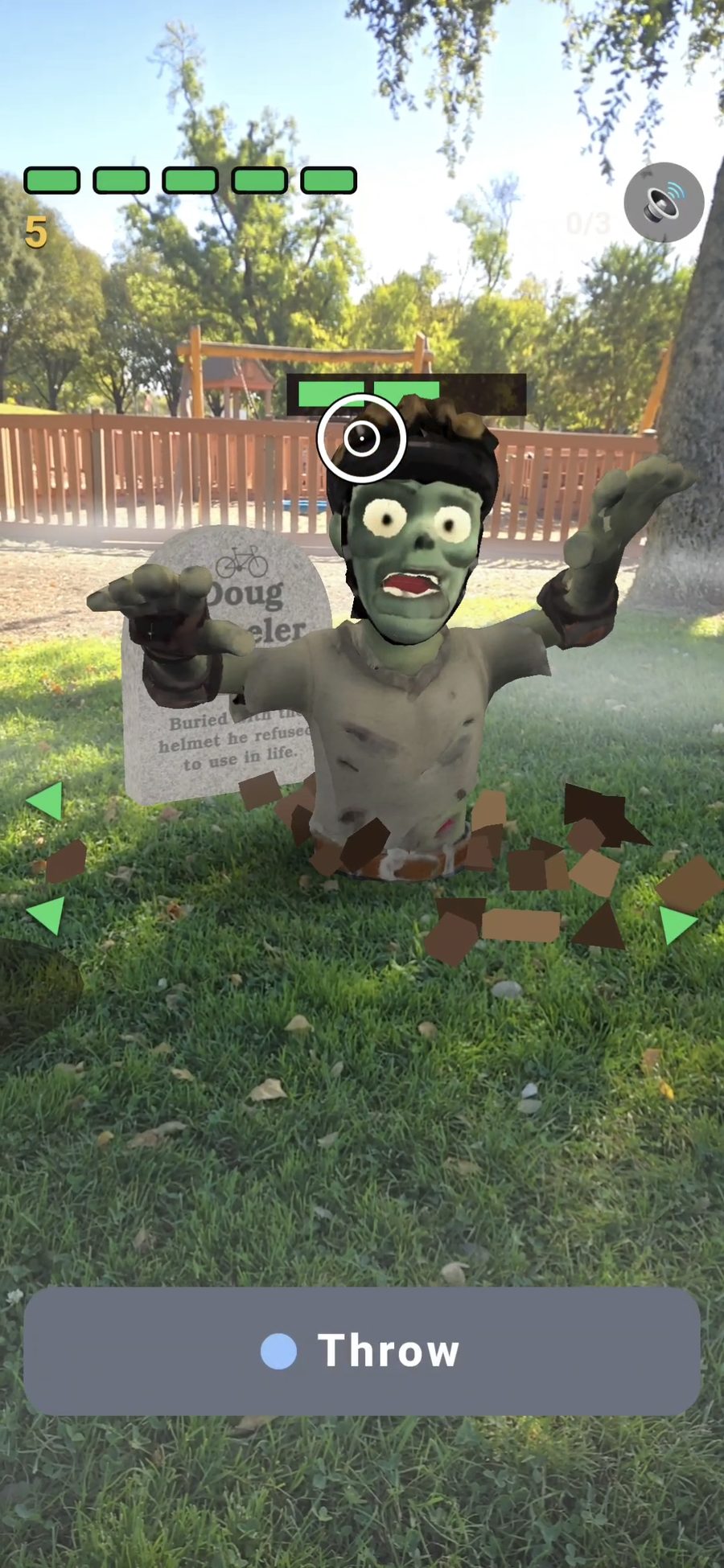 Augmented reality zombie rising from the grass at Community Park beside a headstone reading Doug Wheeler, buried with the helmet he refused to use in life.
