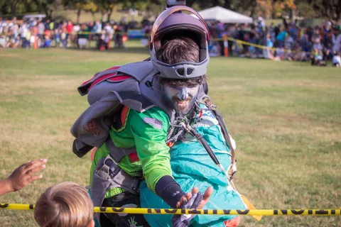 Children lean over the tape for a high five after the jump.