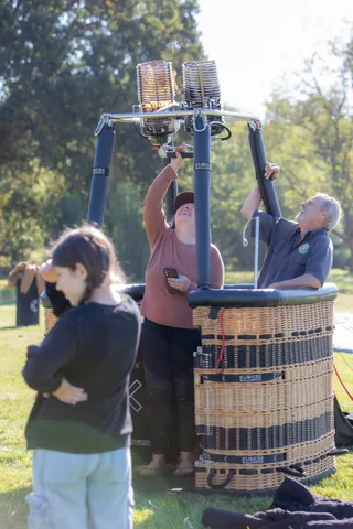 Crew check the burners above a balloon basket